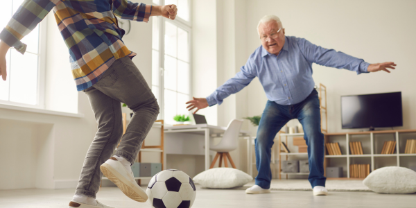 man playing soccer with his grandson