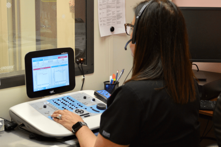 audiologist conducting a hearing test