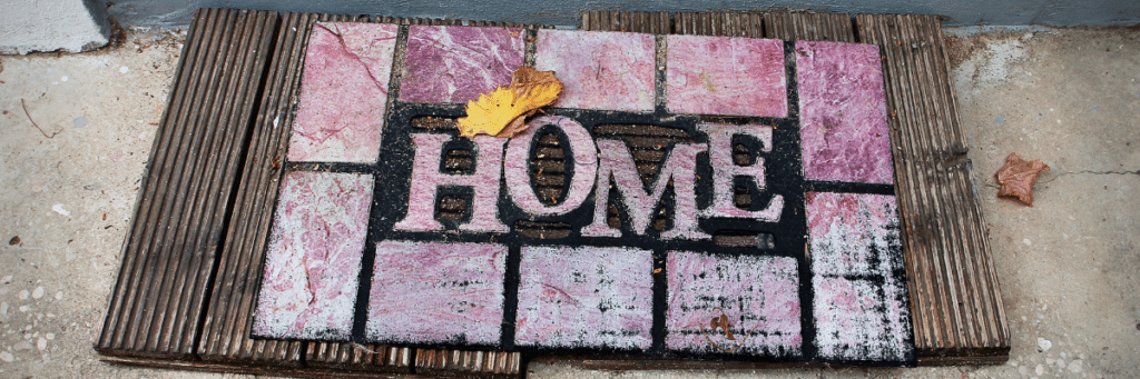 a welcome mat that says "home"