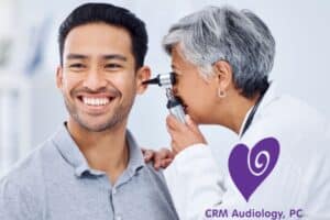 doctor looking in man's ear