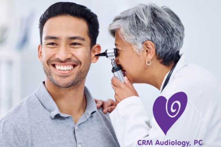 doctor looking in man's ear