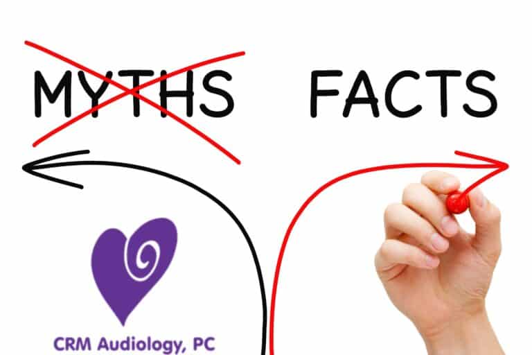 hand writing on a whiteboard crossing out the word myths and drawing an arrow to the word facts