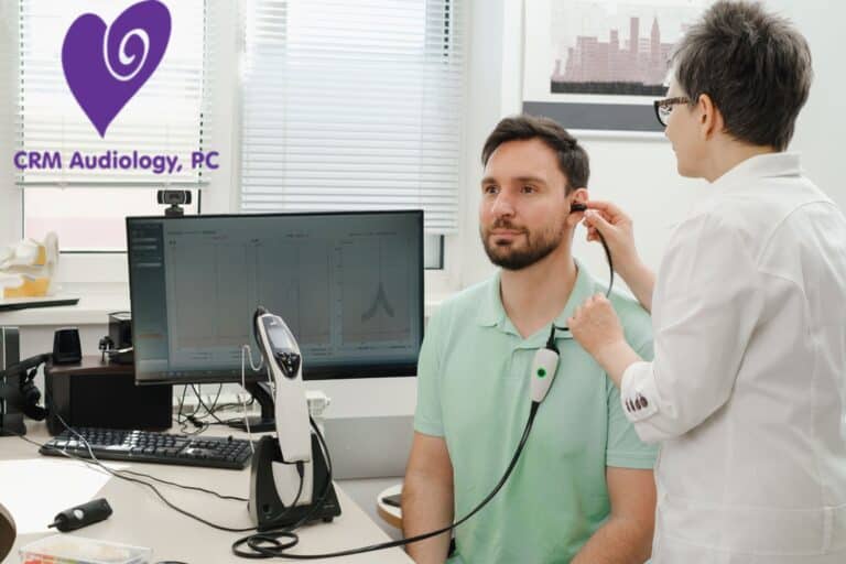 audiologist checking patients ear