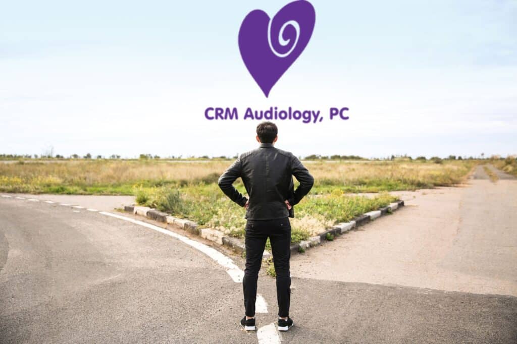 man standing at a fork in the road