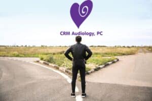 man standing at a fork in the road