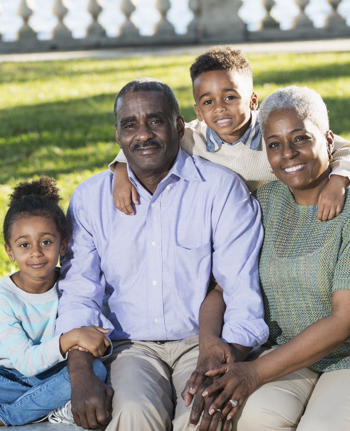Family of four smiling outdoors